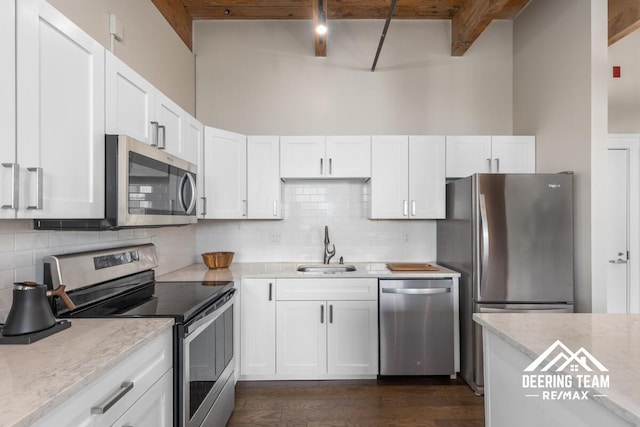 940 Monroe Ave NW Unit 335, Grand Rapids, MI 49503 - kitchen with appliances with stainless steel finishes, a sink, white cabinets, dark wood-style floors, and light stone countertops