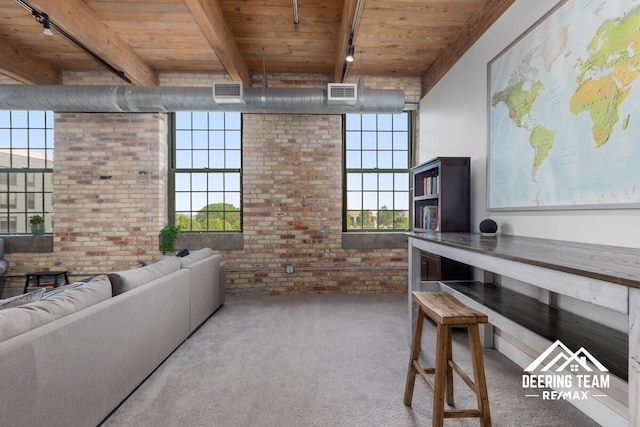 940 Monroe Ave NW Unit 335, Grand Rapids, MI 49503 - carpeted living room with brick wall, wood ceiling with exposed beams, and plenty of natural light