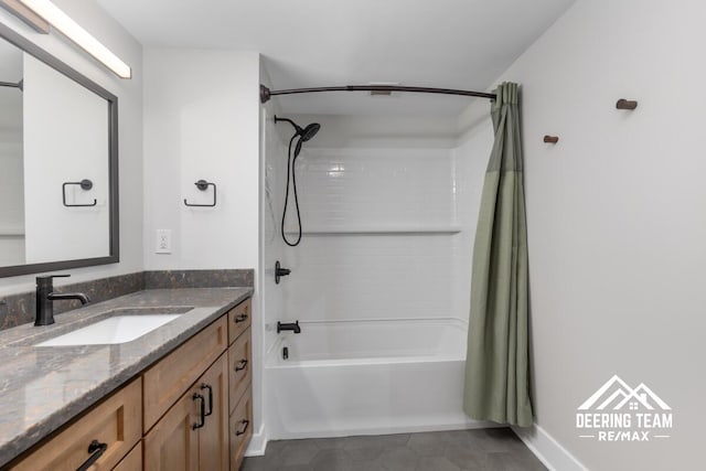 940 Monroe Ave NW Unit 335, Grand Rapids, MI 49503 - full bathroom featuring shower / bath combo with shower curtain, vanity, and tile patterned flooring