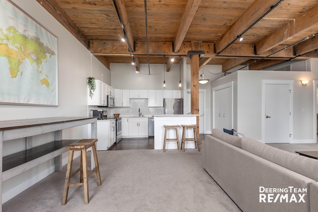 940 Monroe Ave NW Unit 335, Grand Rapids, MI 49503 - carpeted living area featuring a wooden ceiling with exposed beams and a sink