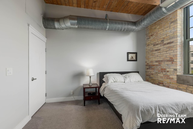 940 Monroe Ave NW Unit 335, Grand Rapids, MI 49503 - bedroom featuring carpet floors and brick wall