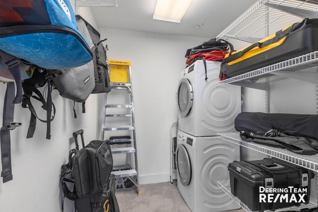 940 Monroe Ave NW Unit 335, Grand Rapids, MI 49503 - washroom featuring stacked washer / drying machine and carpet
