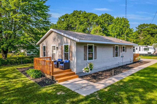 1446 Riblet Rd, Muskegon, MI 49445 - view of front of property featuring a wooden deck, a front lawn, and roof with shingles