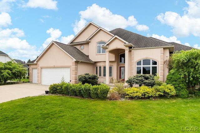 1269 Scott Ridge Dr, Adrian, MI 49221 - view of front of property with stucco siding, a garage, a front lawn, and driveway