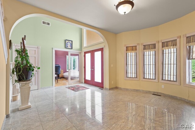 1269 Scott Ridge Dr, Adrian, MI 49221 - entryway featuring baseboards, french doors, arched walkways, and a high ceiling