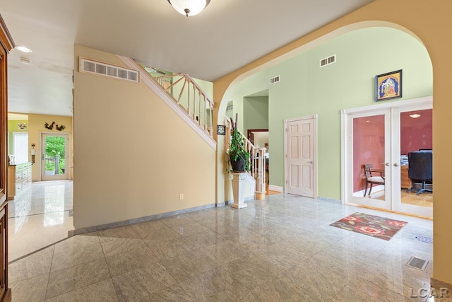 1269 Scott Ridge Dr, Adrian, MI 49221 - entrance foyer with arched walkways, french doors, a towering ceiling, baseboards, and granite tiled floors