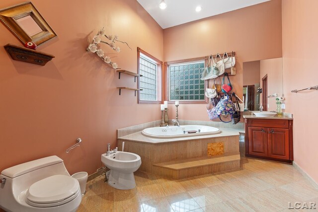 1269 Scott Ridge Dr, Adrian, MI 49221 - bathroom with toilet, a bidet, a bath, vanity, and baseboards