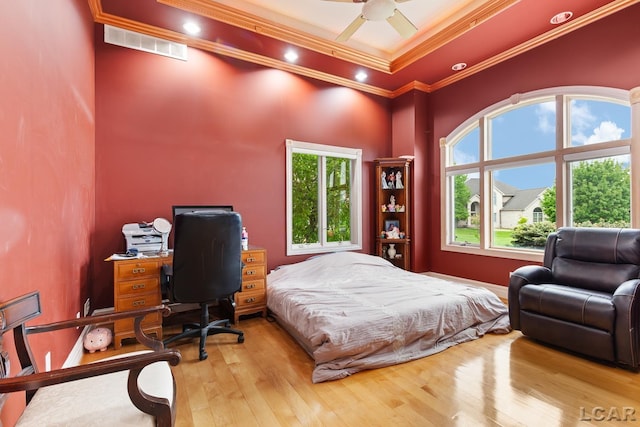 1269 Scott Ridge Dr, Adrian, MI 49221 - bedroom featuring a towering ceiling, crown molding, multiple windows, a desk, and wood-type flooring