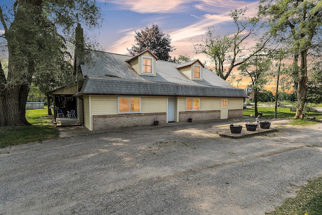2006 W Rose Center Rd, Holly, MI 48442 - property exterior at dusk with brick siding