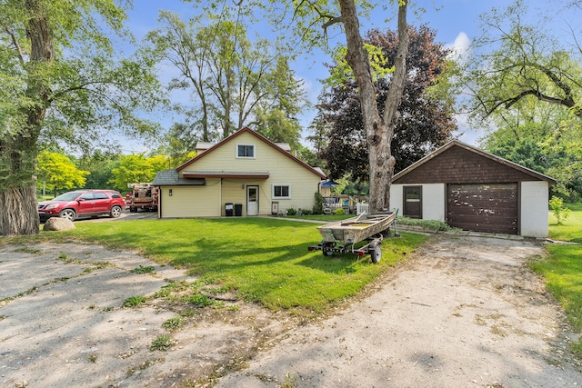 2006 W Rose Center Rd, Holly, MI 48442 - view of front of house featuring a garage, driveway, an outdoor structure, and a front yard