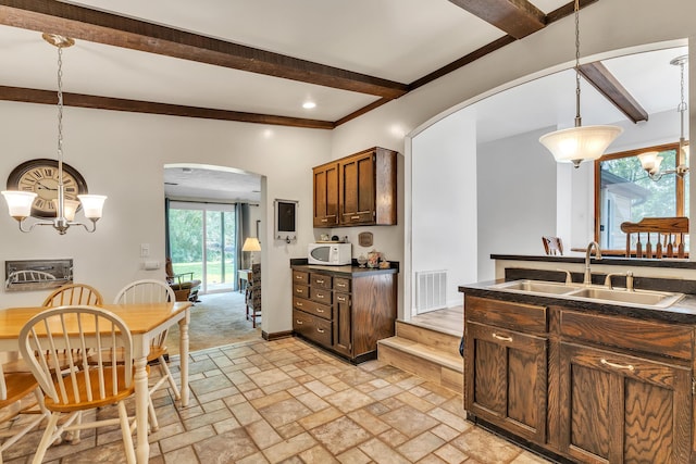 2006 W Rose Center Rd, Holly, MI 48442 - kitchen with a chandelier, arched walkways, a sink, beamed ceiling, and dark countertops