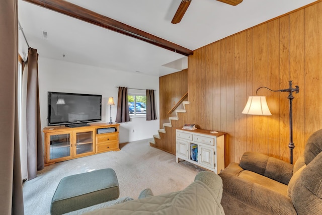 2006 W Rose Center Rd, Holly, MI 48442 - living area with wood walls, carpet floors, ceiling fan, beamed ceiling, and stairway