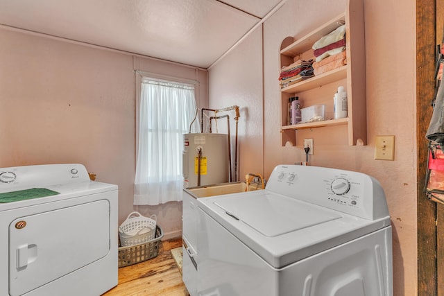 2006 W Rose Center Rd, Holly, MI 48442 - washroom featuring washing machine and clothes dryer, gas water heater, and light wood finished floors