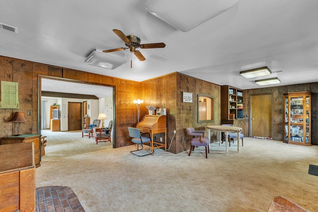 2006 W Rose Center Rd, Holly, MI 48442 - carpeted living room featuring wooden walls and a ceiling fan
