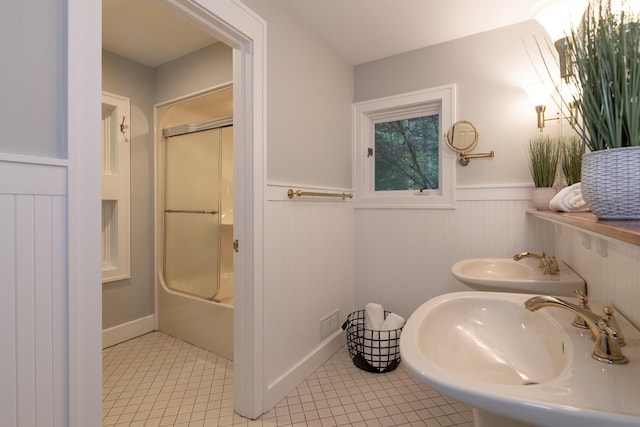 8562 W R Ave, Kalamazoo, MI 49009 - full bath featuring a sink, a wainscoted wall, tile patterned flooring, and bath / shower combo with glass door