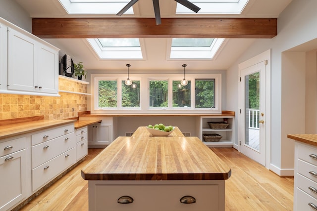 8562 W R Ave, Kalamazoo, MI 49009 - kitchen featuring a skylight, wooden counters, and backsplash