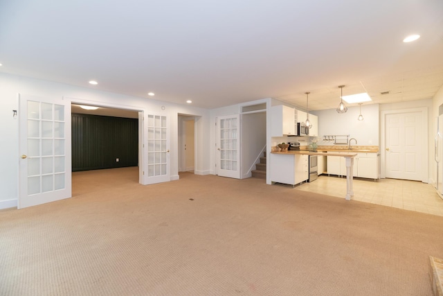 8562 W R Ave, Kalamazoo, MI 49009 - basement featuring french doors, light carpet, recessed lighting, a sink, and baseboards