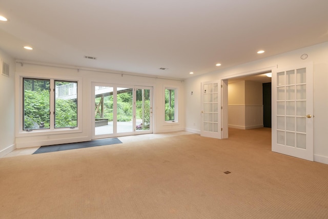 8562 W R Ave, Kalamazoo, MI 49009 - empty room featuring french doors, plenty of natural light, light carpet, baseboards, and recessed lighting