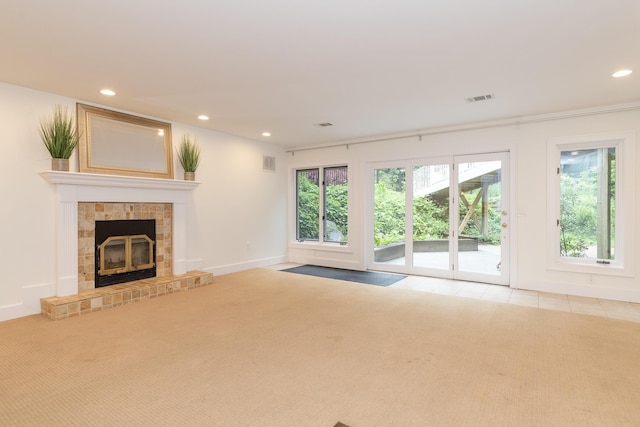 8562 W R Ave, Kalamazoo, MI 49009 - unfurnished living room with carpet, recessed lighting, a glass covered fireplace, baseboards, and tile patterned floors
