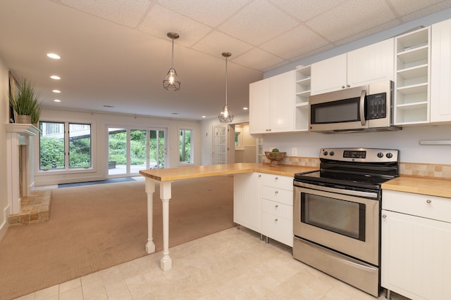 8562 W R Ave, Kalamazoo, MI 49009 - kitchen featuring open shelves, appliances with stainless steel finishes, plenty of natural light, white cabinets, and recessed lighting