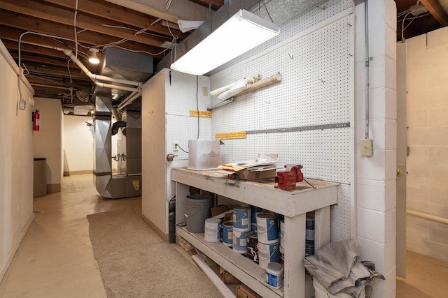 8562 W R Ave, Kalamazoo, MI 49009 - unfinished basement with a workshop area, heating unit, and baseboards
