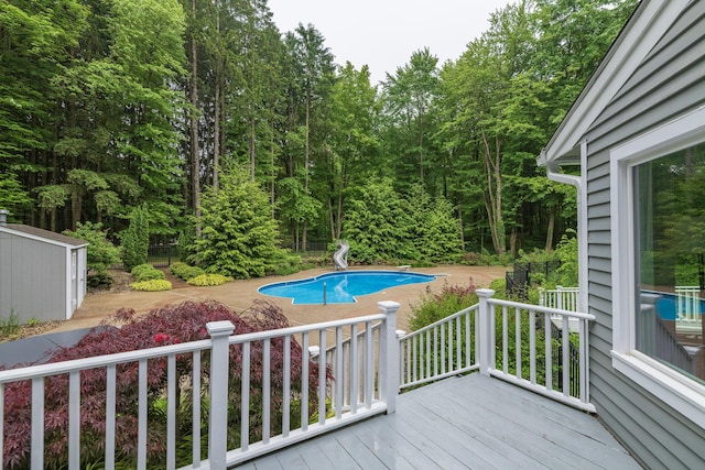 8562 W R Ave, Kalamazoo, MI 49009 - deck with an outdoor pool, a patio, and an outbuilding