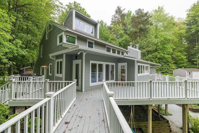 8562 W R Ave, Kalamazoo, MI 49009 - back of property with a wooden deck and a chimney