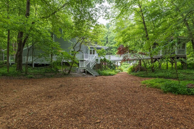 8562 W R Ave, Kalamazoo, MI 49009 - view of yard featuring a wooden deck and stairs