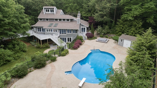 8562 W R Ave, Kalamazoo, MI 49009 - outdoor pool featuring stairway, a diving board, a patio, and a wooden deck