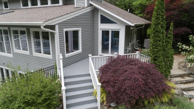 8562 W R Ave, Kalamazoo, MI 49009 - view of side of home featuring stairs and a shingled roof