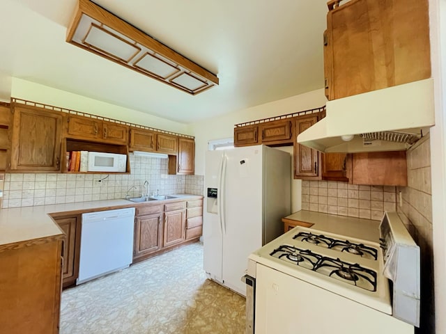 15522 Kimball Rd, Trufant, MI 49347 - kitchen with white appliances, a sink, tasteful backsplash, and brown cabinetry