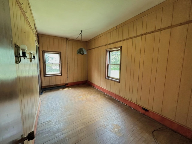 15522 Kimball Rd, Trufant, MI 49347 - empty room featuring light wood-type flooring and wood walls