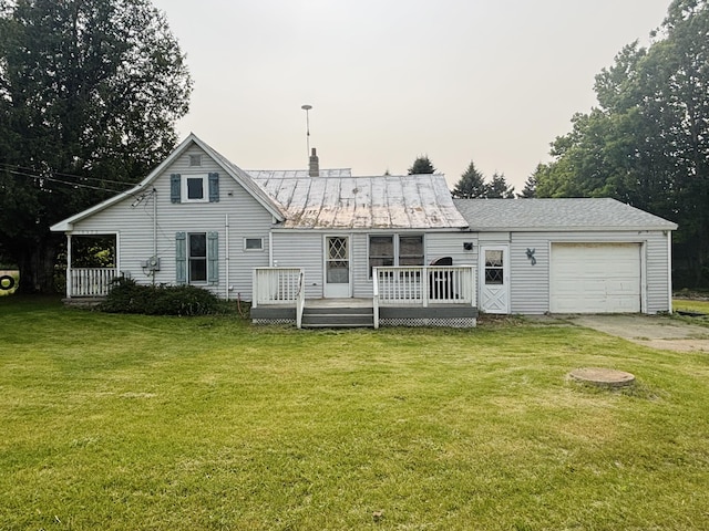 15522 Kimball Rd, Trufant, MI 49347 - back of property featuring an attached garage, a lawn, metal roof, and a wooden deck