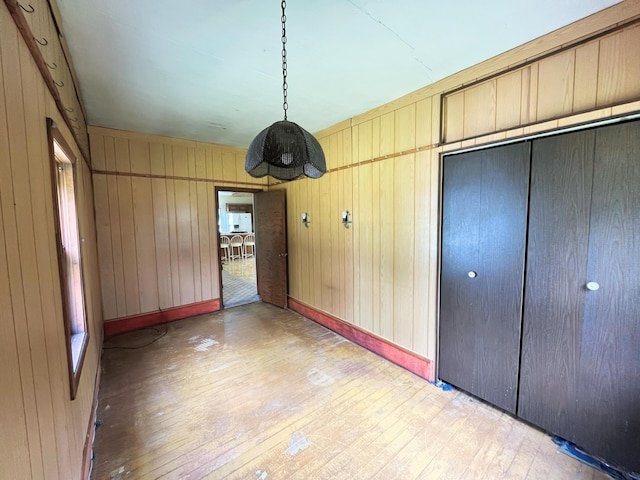 15522 Kimball Rd, Trufant, MI 49347 - unfurnished dining area with light wood finished floors, wooden walls, and baseboards