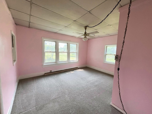 15522 Kimball Rd, Trufant, MI 49347 - carpeted spare room featuring baseboard heating, a paneled ceiling, baseboards, and ceiling fan