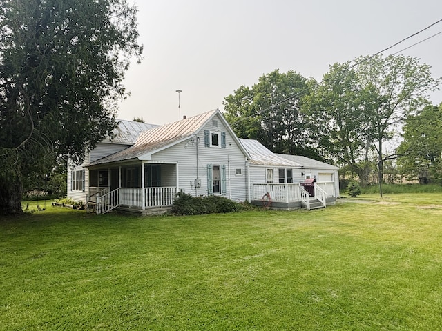 15522 Kimball Rd, Trufant, MI 49347 - back of property featuring a porch, a lawn, and metal roof