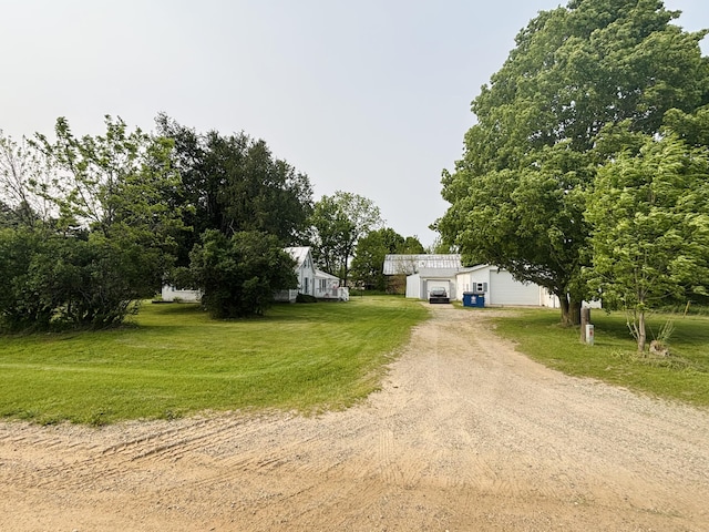 15522 Kimball Rd, Trufant, MI 49347 - view of front of home with driveway, a front lawn, an outbuilding, and a detached garage