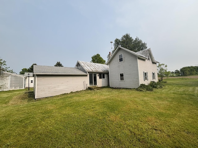 15522 Kimball Rd, Trufant, MI 49347 - back of property featuring a lawn, a chimney, and entry steps