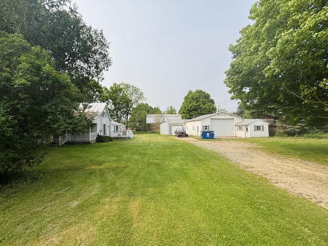 15522 Kimball Rd, Trufant, MI 49347 - view of grassy yard with an outdoor structure, a detached garage, and dirt driveway