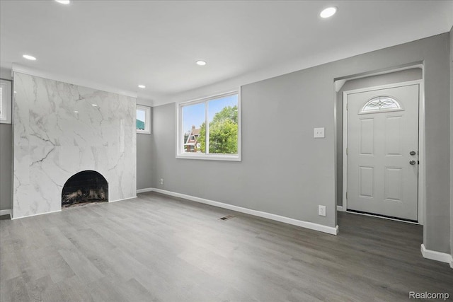 18287 Santa Rosa Dr, Dearborn, MI 48221 - unfurnished living room featuring baseboards, recessed lighting, wood finished floors, and a premium fireplace