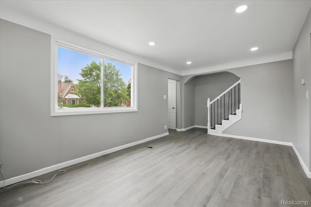 18287 Santa Rosa Dr, Dearborn, MI 48221 - unfurnished room featuring wood finished floors, stairs, recessed lighting, baseboards, and arched walkways