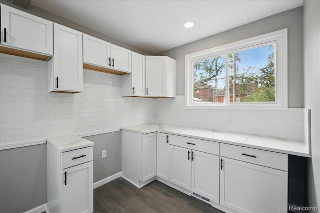 18287 Santa Rosa Dr, Dearborn, MI 48221 - kitchen featuring light stone countertops, dark wood finished floors, backsplash, white cabinets, and recessed lighting