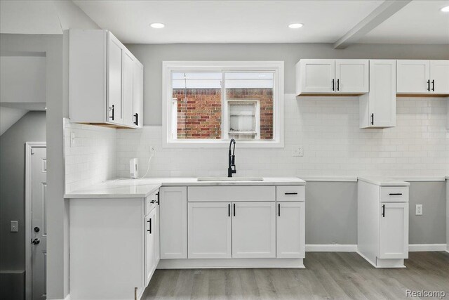 18287 Santa Rosa Dr, Dearborn, MI 48221 - kitchen with a sink, light wood-type flooring, decorative backsplash, white cabinets, and recessed lighting