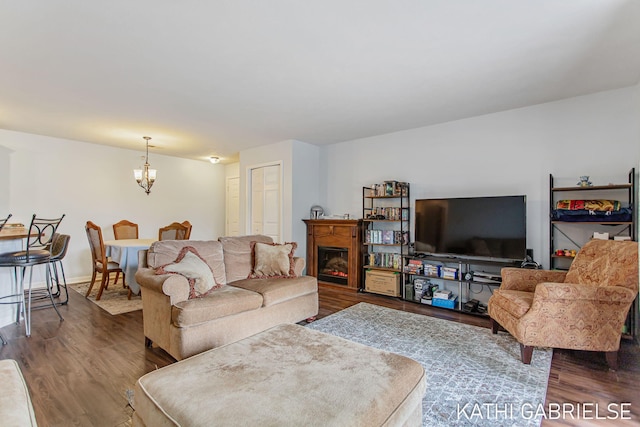 5869 Crosswinds Dr Unit 21, Norton Shores, MI 49444 - living room featuring dark wood-type flooring, a chandelier, and a fireplace