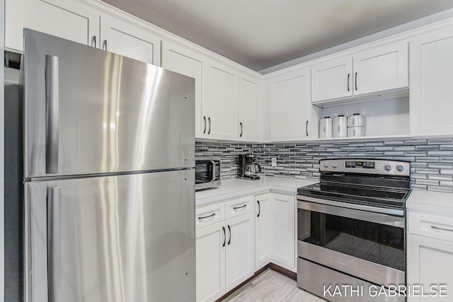 5869 Crosswinds Dr Unit 21, Norton Shores, MI 49444 - kitchen featuring appliances with stainless steel finishes, open shelves, light countertops, and white cabinetry