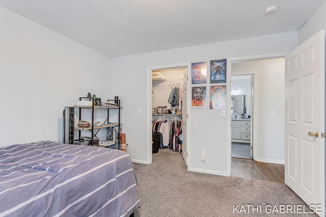 5869 Crosswinds Dr Unit 21, Norton Shores, MI 49444 - carpeted bedroom with a spacious closet, baseboards, and a closet
