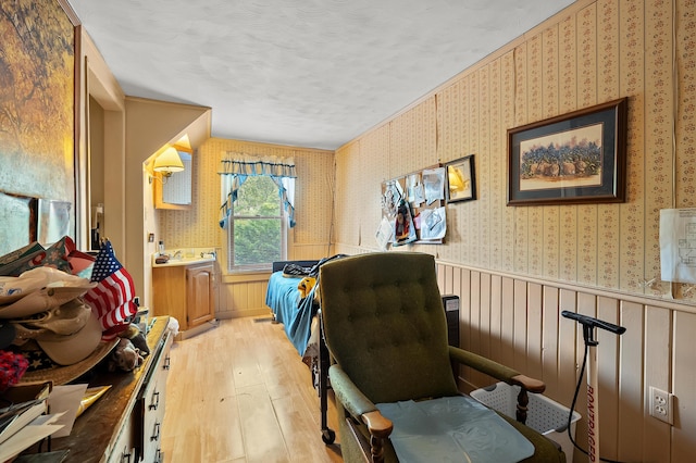 122 N Robinson St, Schoolcraft, MI 49087 - home office featuring light wood-type flooring, wallpapered walls, and a textured ceiling