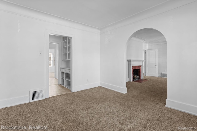 4387 Pingree St, Detroit, MI 48204 - spare room with carpet, a fireplace, crown molding, baseboards, and arched walkways