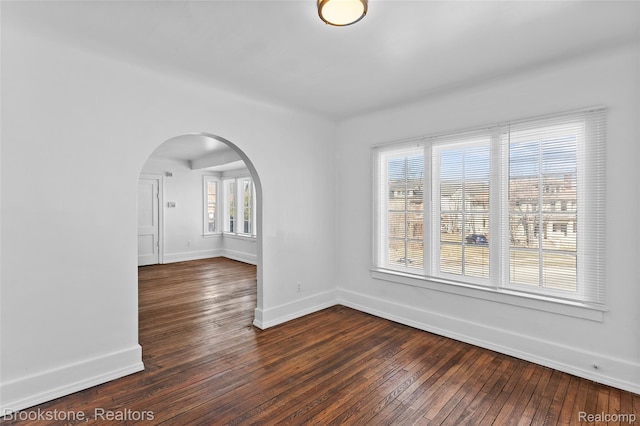 4387 Pingree St, Detroit, MI 48204 - unfurnished room with arched walkways, dark wood finished floors, and baseboards