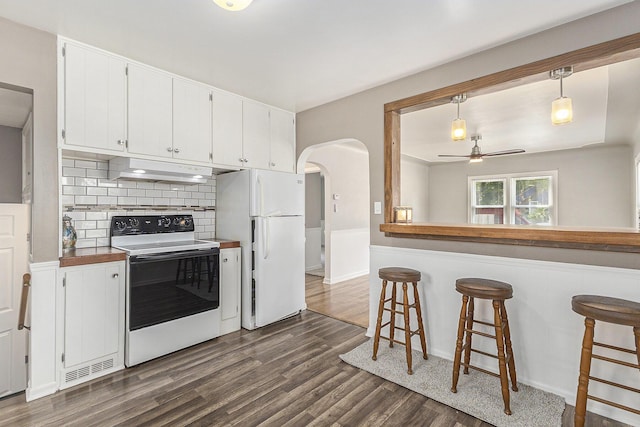 488 Roberts St, Muskegon, MI 49442 - kitchen with white appliances, under cabinet range hood, ceiling fan, dark wood-type flooring, and white cabinets